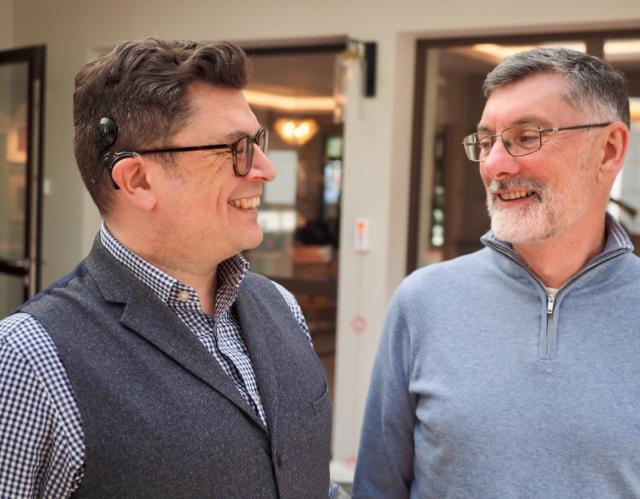 Andrew and Padraic looking at each other and smiling