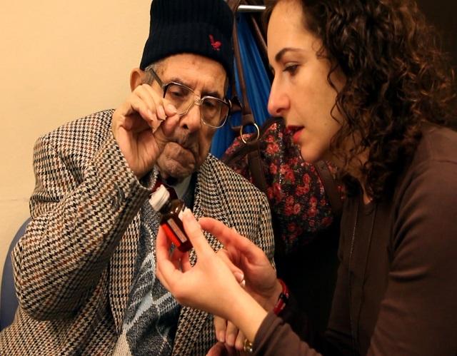 Support Worker explaining dosage of pills to deaf man 