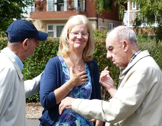 Deafblind man in park with volunteer 